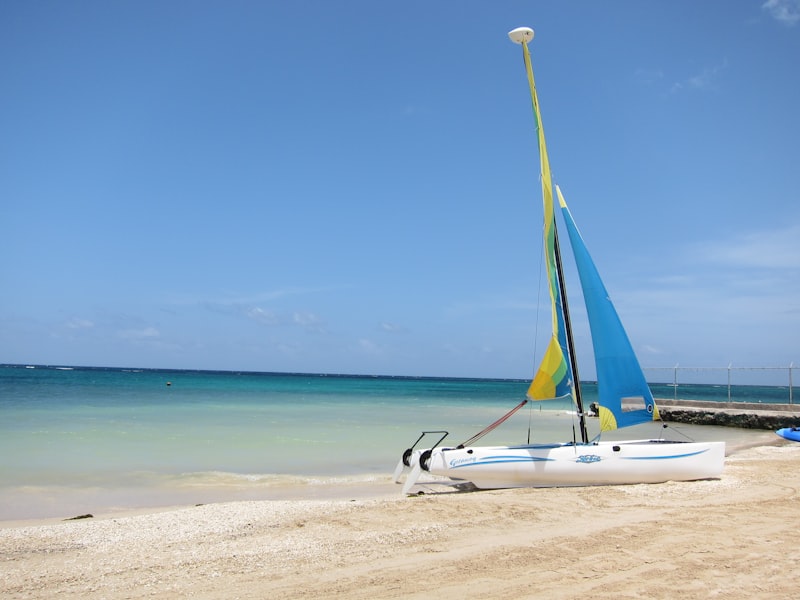 A catamaran on a Jamaica beach under a blue sky